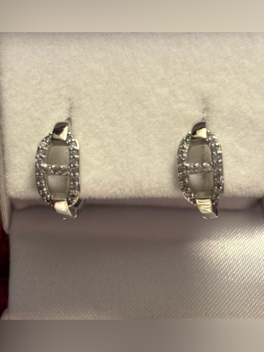 Pavé Oval Huggie Hoop Earrings in Silver Tone with sparkly crystals